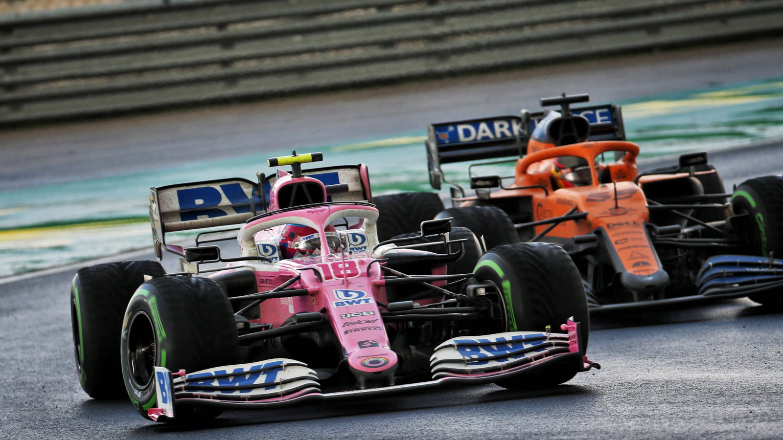 Lance Stroll (CDN) Racing Point F1 Team RP20 and Carlos Sainz Jr (ESP) McLaren MCL35 battle for position.