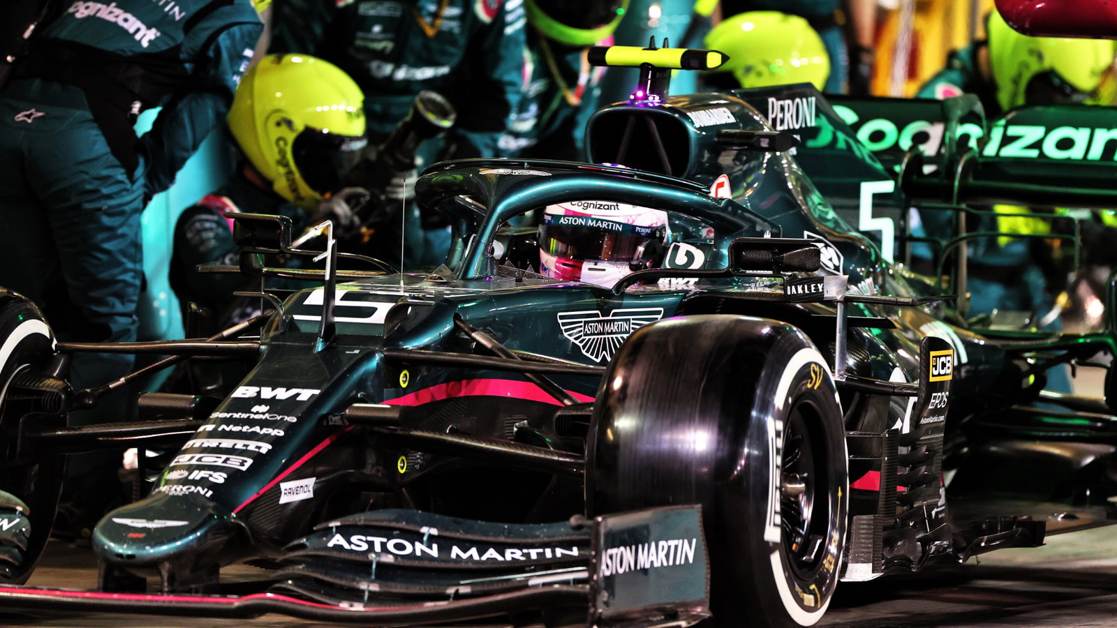 Sebastian Vettel (GER) Aston Martin F1 Team AMR21 makes a pit stop.