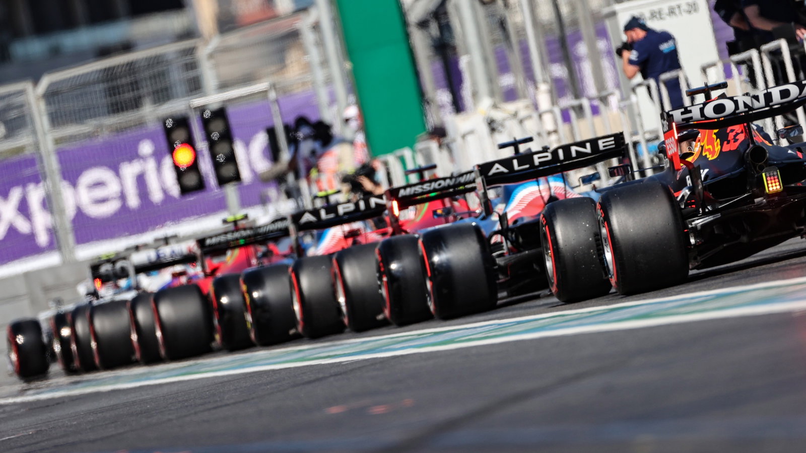 Fernando Alonso (ESP) Alpine F1 Team A521 and Max Verstappen (NLD) Red Bull Racing RB16B at the end of a queue of cars leaving the pits.