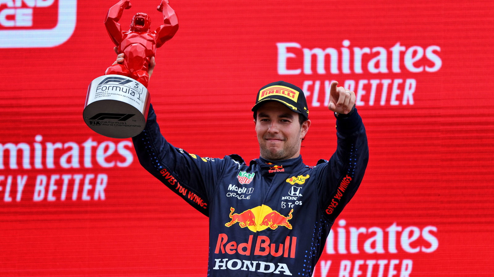 Sergio Perez (MEX) Red Bull Racing celebrates his third position on the podium.