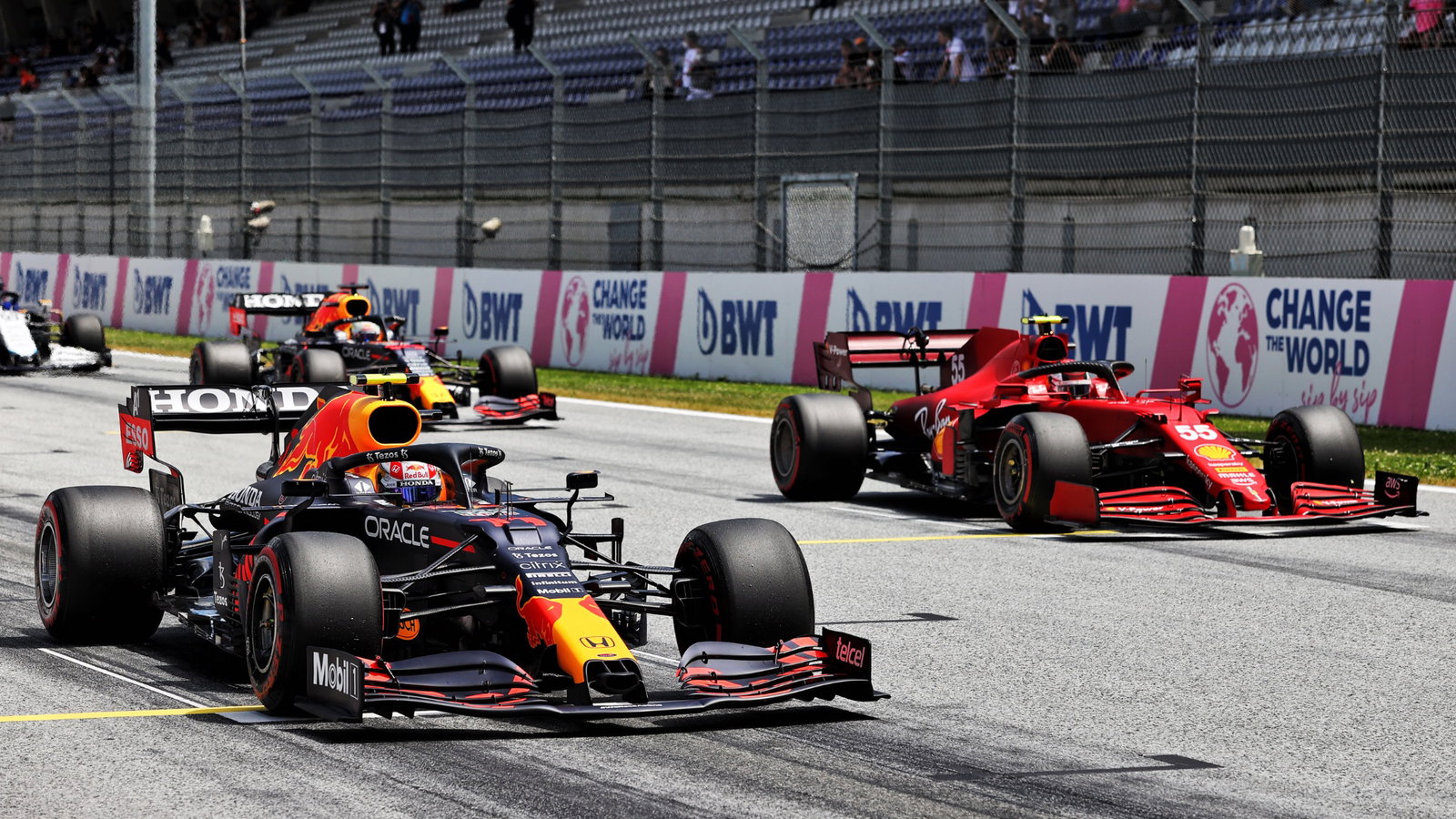 Sergio Perez (MEX) Red Bull Racing RB16B and Carlos Sainz Jr (ESP) Ferrari SF-21 - practice starts.