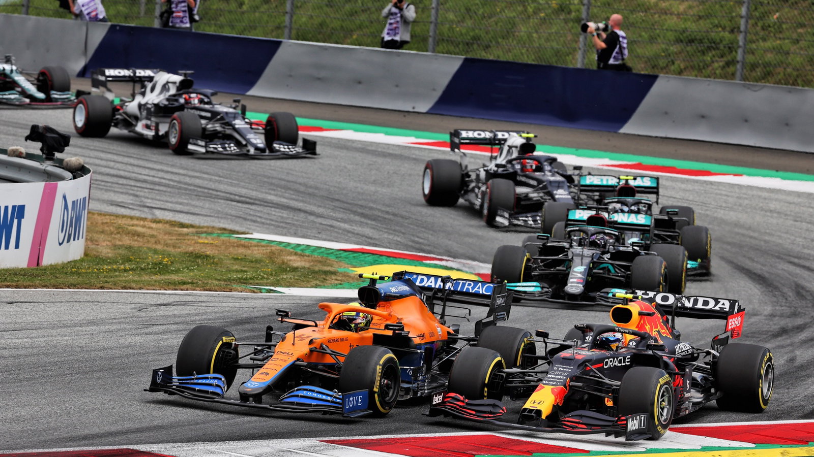 Lando Norris (GBR) McLaren MCL35M and Sergio Perez (MEX) Red Bull Racing RB16B battle for position.