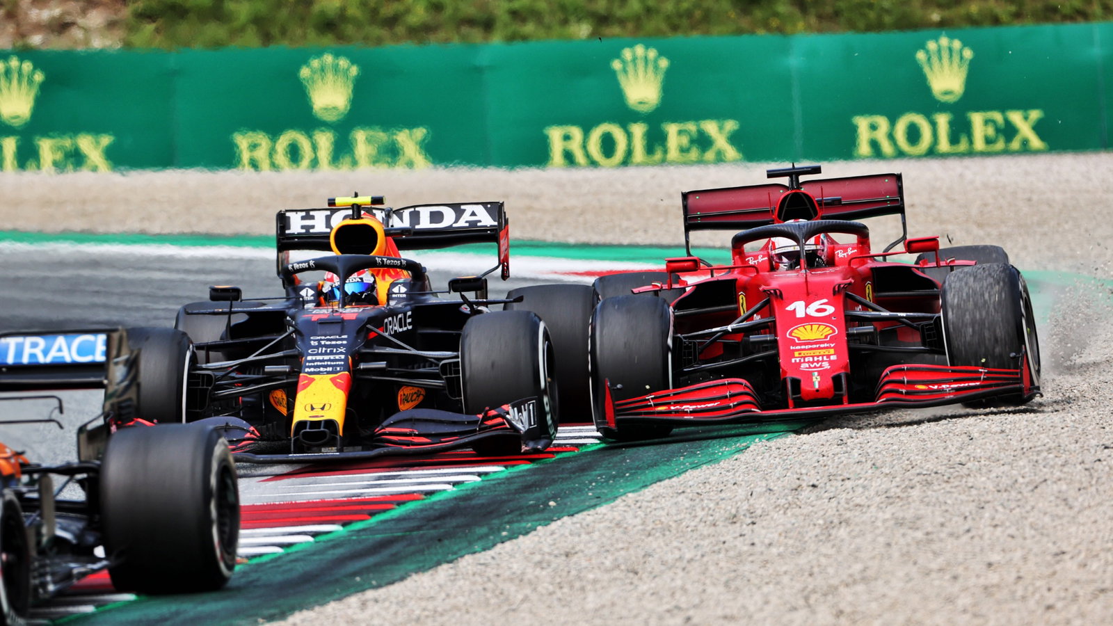 Sergio Perez (MEX) Red Bull Racing RB16B and Charles Leclerc (MON) Ferrari SF-21 battle for position.