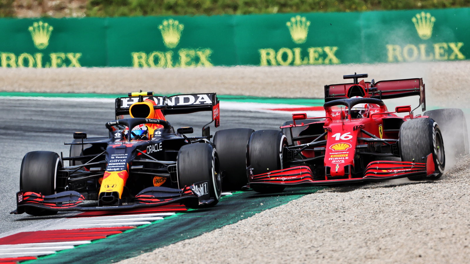 Sergio Perez (MEX) Red Bull Racing RB16B and Charles Leclerc (MON) Ferrari SF-21 battle for position.