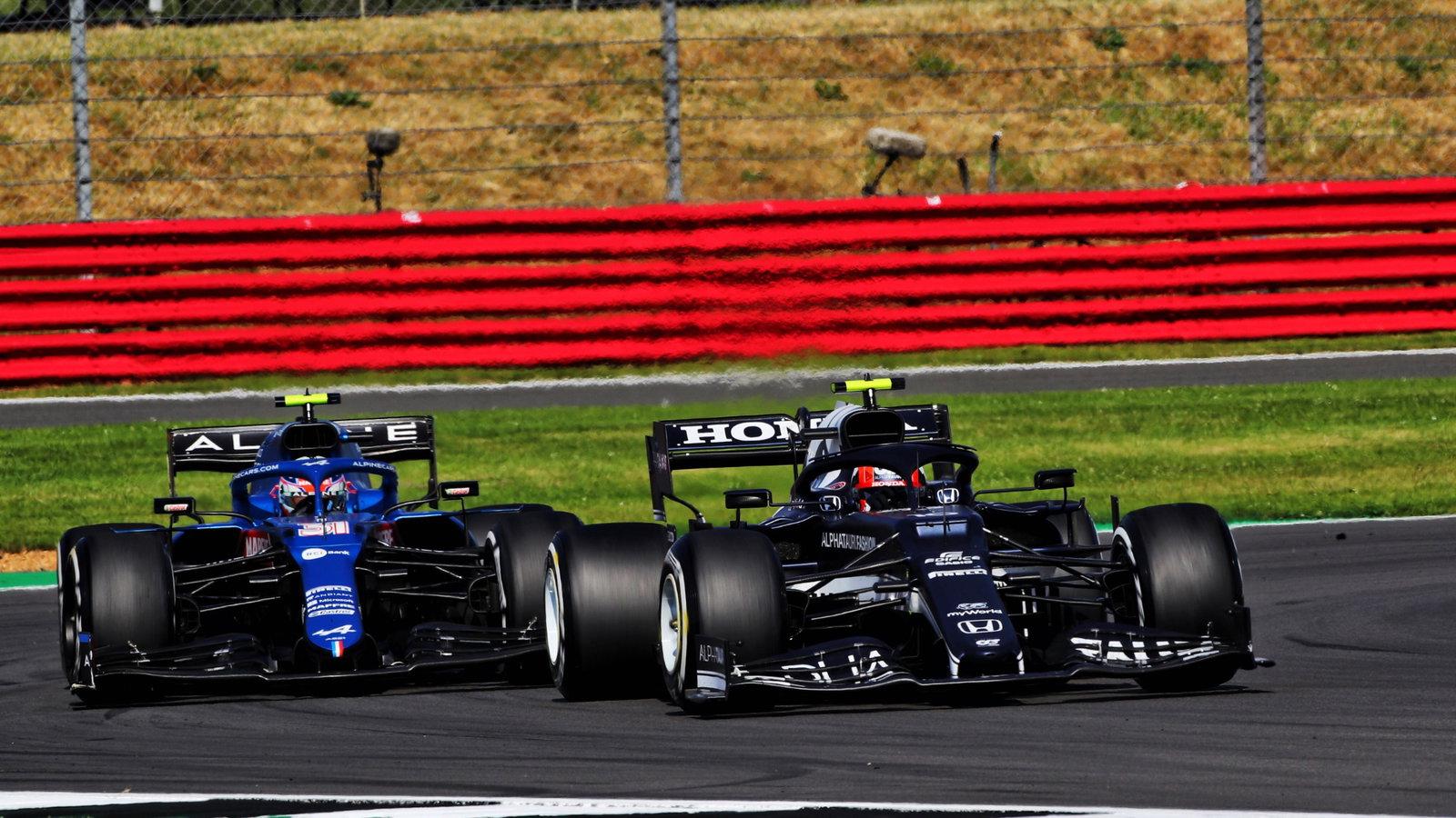 Esteban Ocon (FRA) Alpine F1 Team A521 and Pierre Gasly (FRA) AlphaTauri AT02 battle for position.