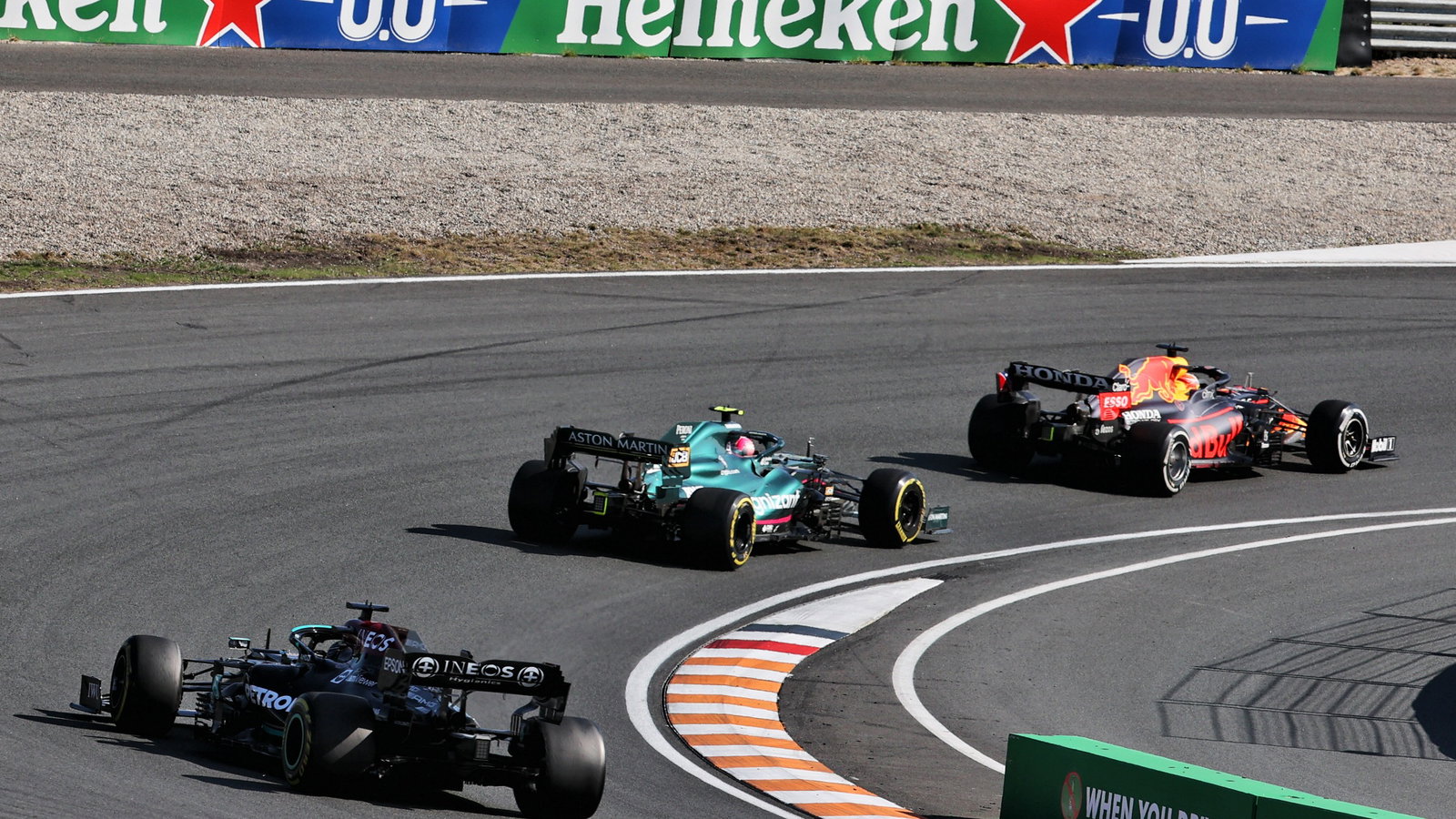 Max Verstappen (NLD) Red Bull Racing RB16B leads Sebastian Vettel (GER) Aston Martin F1 Team AMR21 and Lewis Hamilton (GBR) Mercedes AMG F1 W12.
