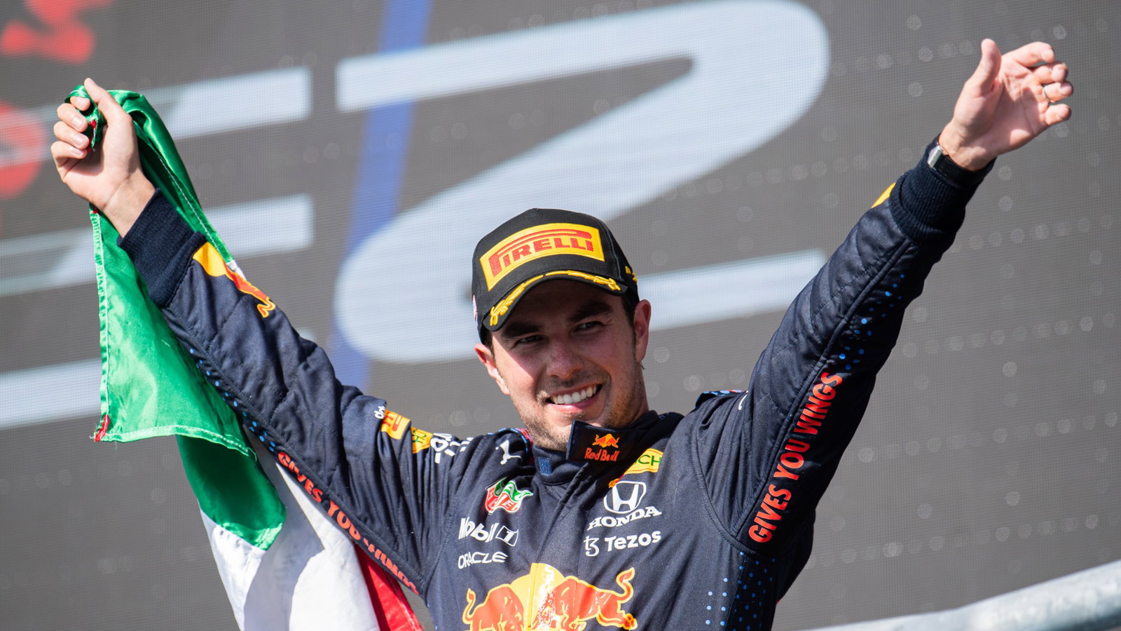 Sergio Perez (MEX) Red Bull Racing celebrates his third position on the podium.