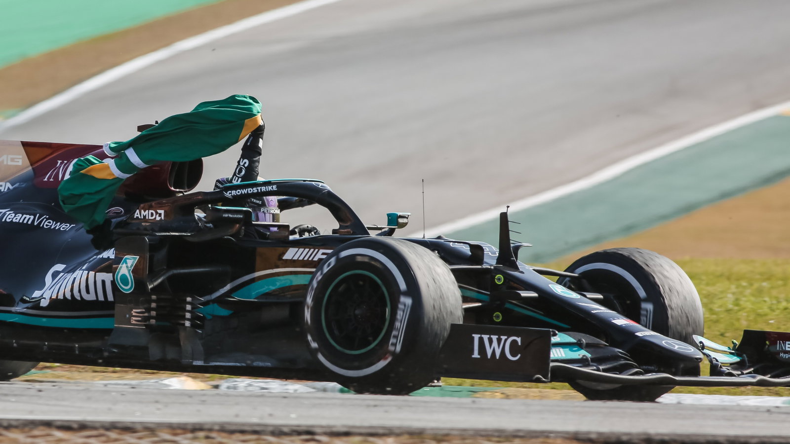 Race winner Lewis Hamilton (GBR) Mercedes AMG F1 W12 celebrates carrying the Brazilian flag at the end of the race.