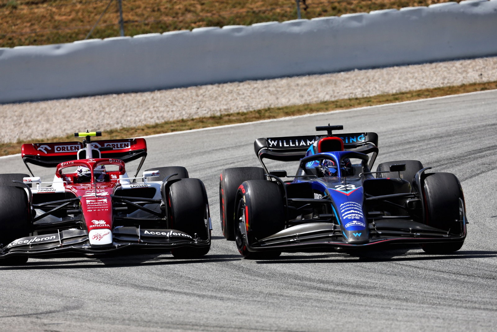 Guanyu Zhou (CHN) Alfa Romeo F1 Team C42 and Alexander Albon (THA) Williams Racing FW44 battle for position. Formula 1