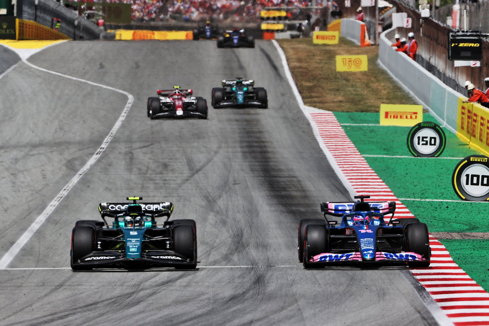 Sebastian Vettel (GER) Aston Martin F1 Team AMR22 and Fernando Alonso (ESP) Alpine F1 Team A522 battle for position.