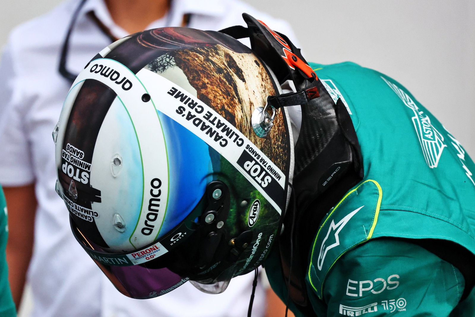 Sebastian Vettel (GER) Aston Martin F1 Team with helmet highlighting Canada's extraction of oil from the Athabasca tar sands