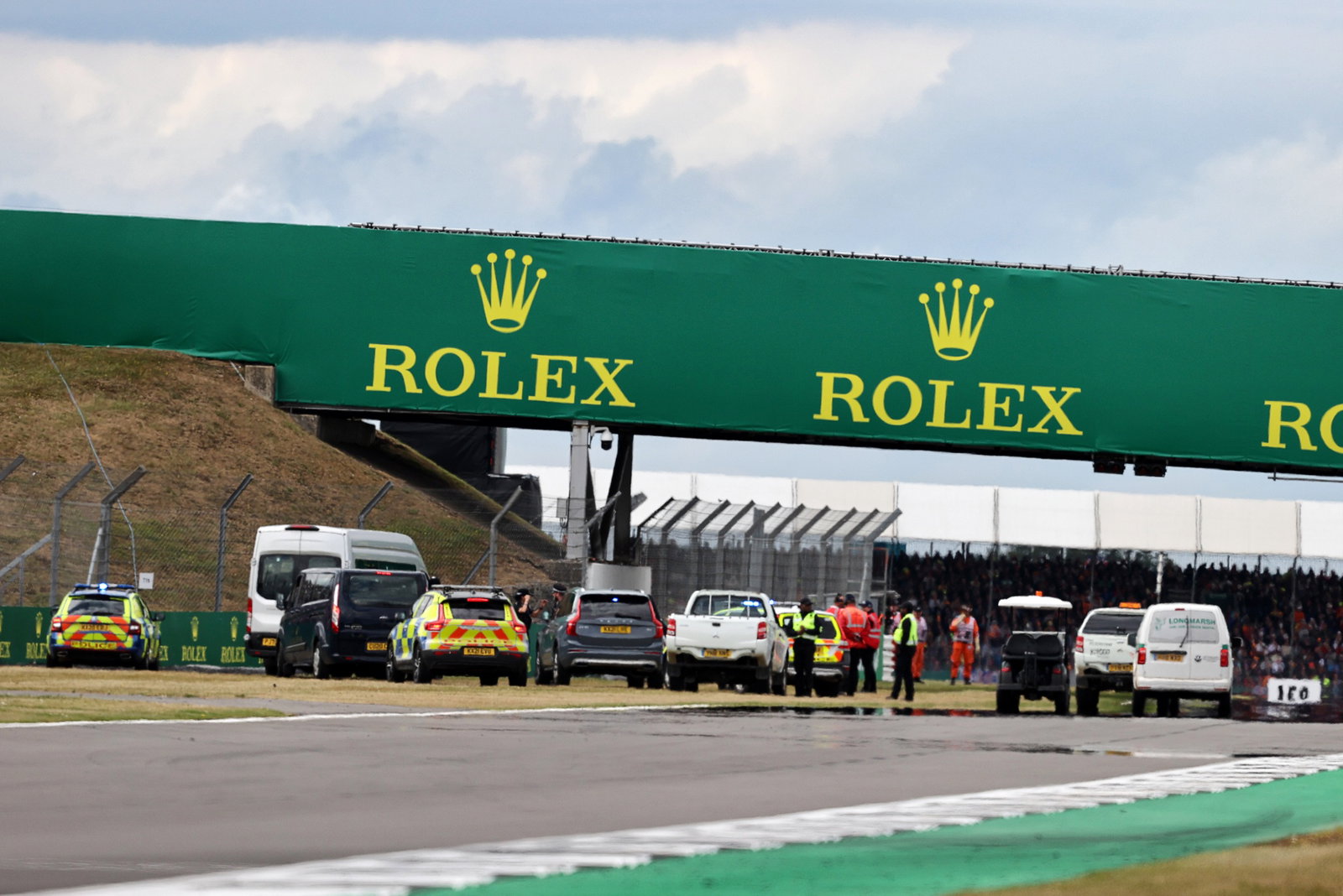 Police on the circuit at the start of the race as an incident involving people attempting to enter the circuit. Formula 1
