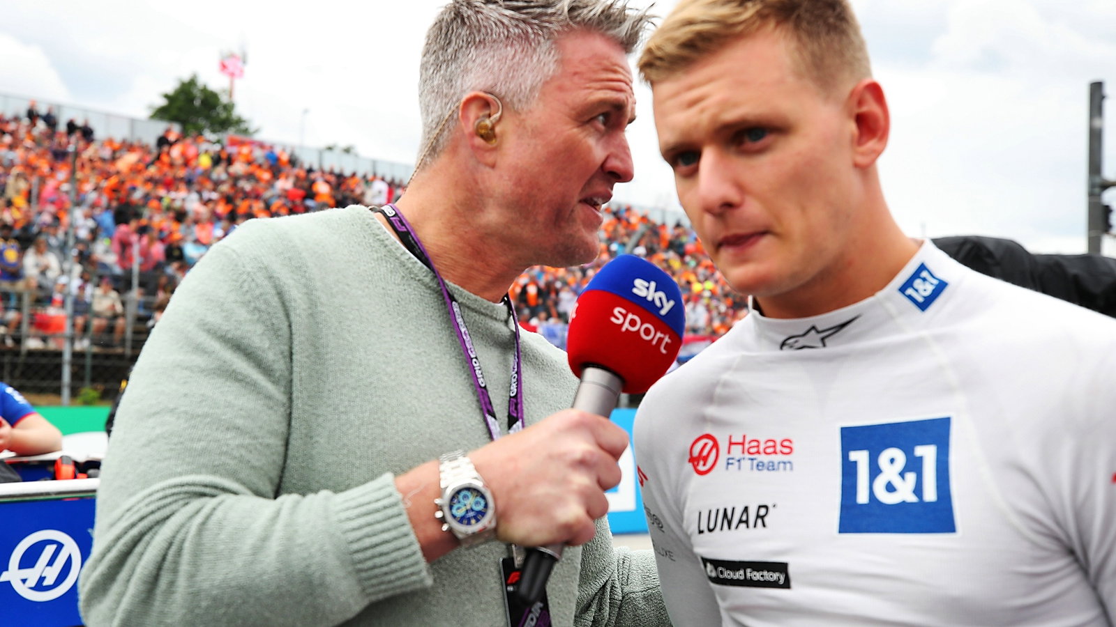 (L to R): Ralf Schumacher (GER) Sky Sport Presenter with Mick Schumacher (GER) Haas F1 Team on the grid. Formula 1 World