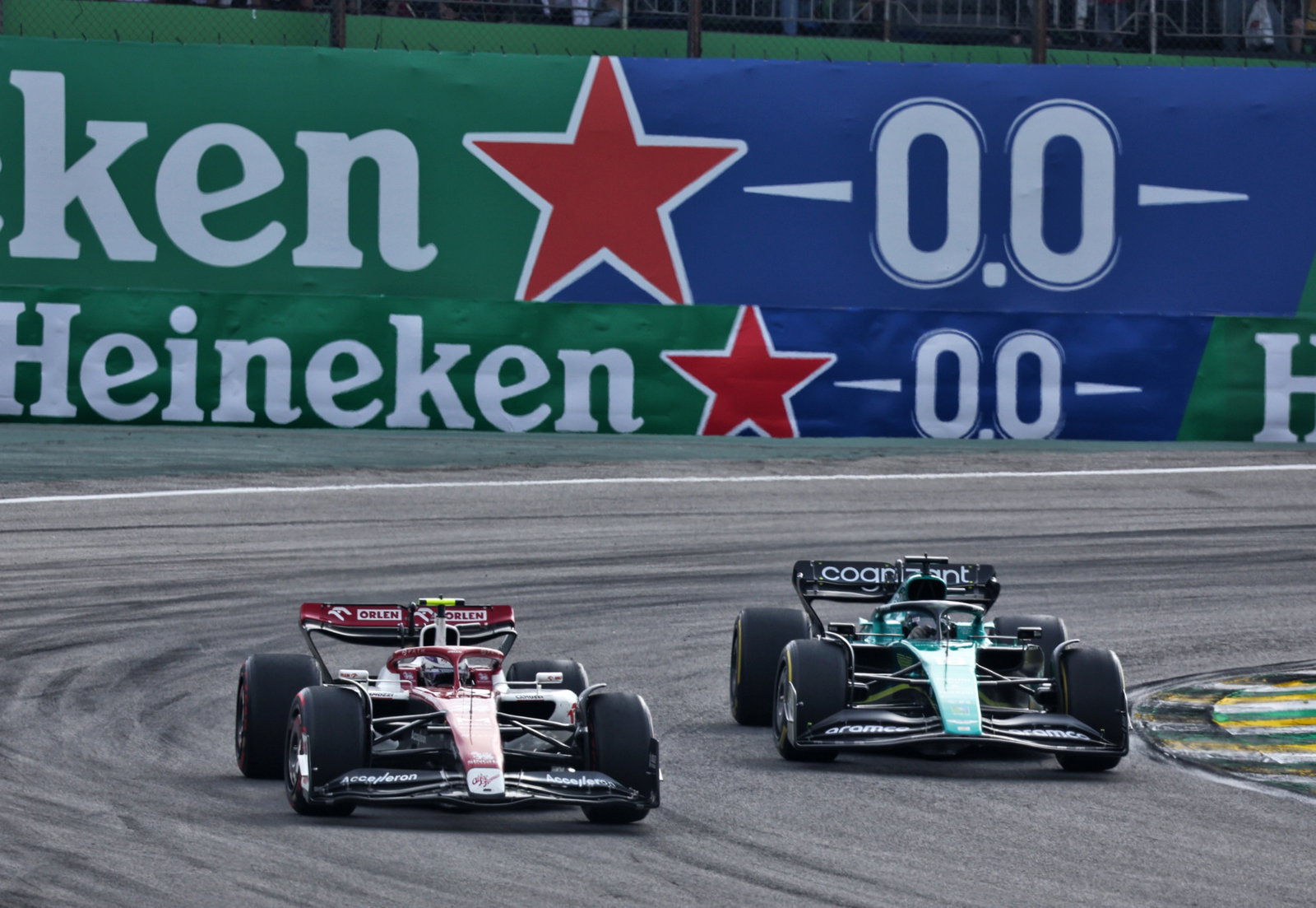 Guanyu Zhou (CHN) Alfa Romeo F1 Team C42 and Lance Stroll (CDN) Aston Martin F1 Team AMR22 battle for position. Formula 1