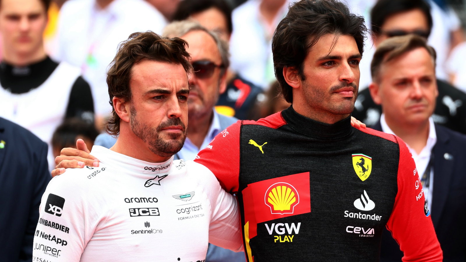 (L to R): Fernando Alonso (ESP) Aston Martin F1 Team and Carlos Sainz Jr (ESP) Ferrari as the grid observes the national
