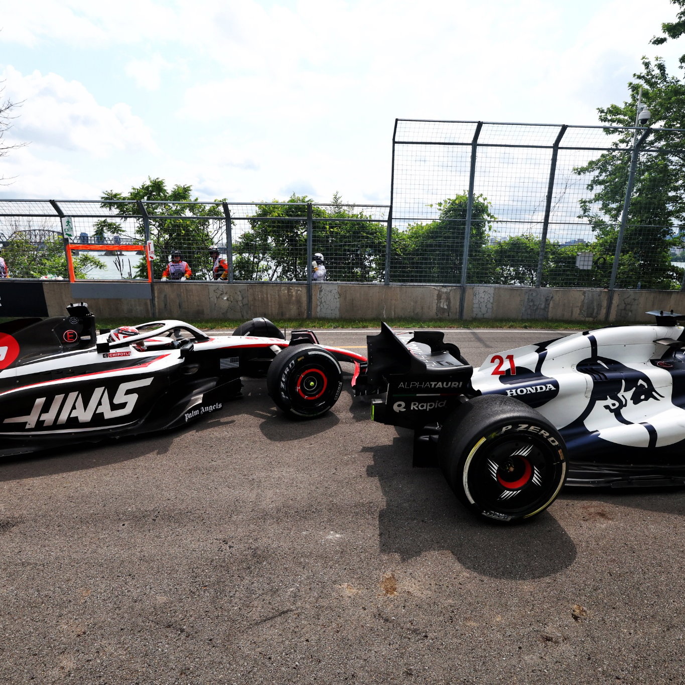 Nyck de Vries (NLD) AlphaTauri AT04 and Kevin Magnussen (DEN) Haas VF-23 run on at the exit road and reverse back on to the