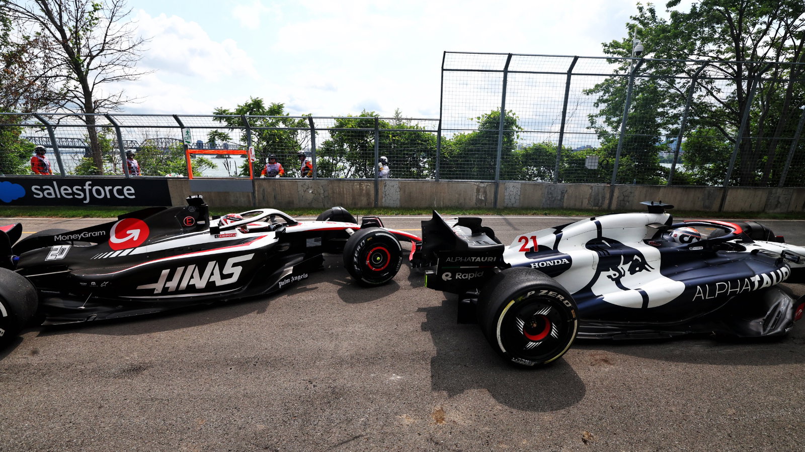 Nyck de Vries (NLD) AlphaTauri AT04 and Kevin Magnussen (DEN) Haas VF-23 run on at the exit road and reverse back on to the