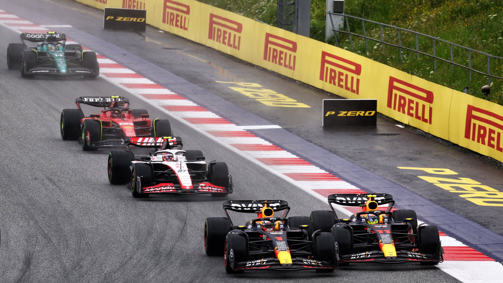(L to R): Max Verstappen (NLD) Red Bull Racing RB19 and team mate Sergio Perez (MEX) Red Bull Racing RB19 battle for the