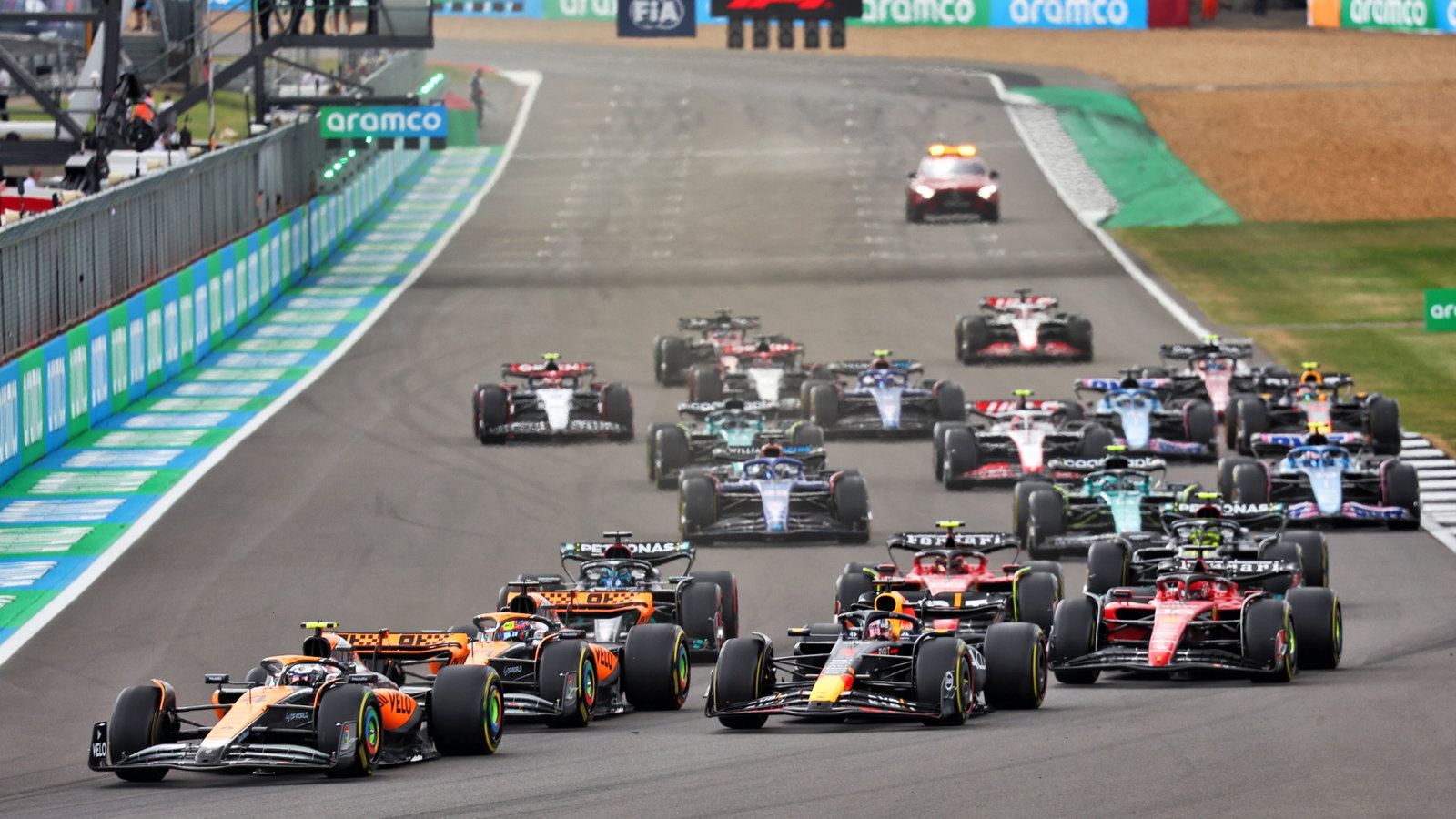 Lando Norris (GBR) McLaren MCL60 leads Max Verstappen (NLD) Red Bull Racing RB19 and Oscar Piastri (AUS) McLaren MCL60 at