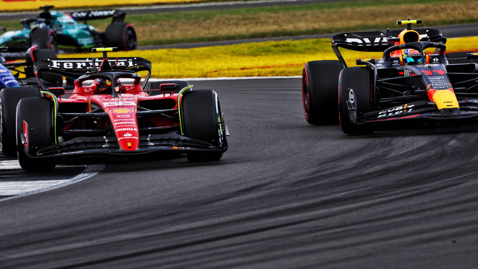 Carlos Sainz Jr (ESP) Ferrari SF-23 and Sergio Perez (MEX) Red Bull Racing RB19 battle for position. Formula 1 World