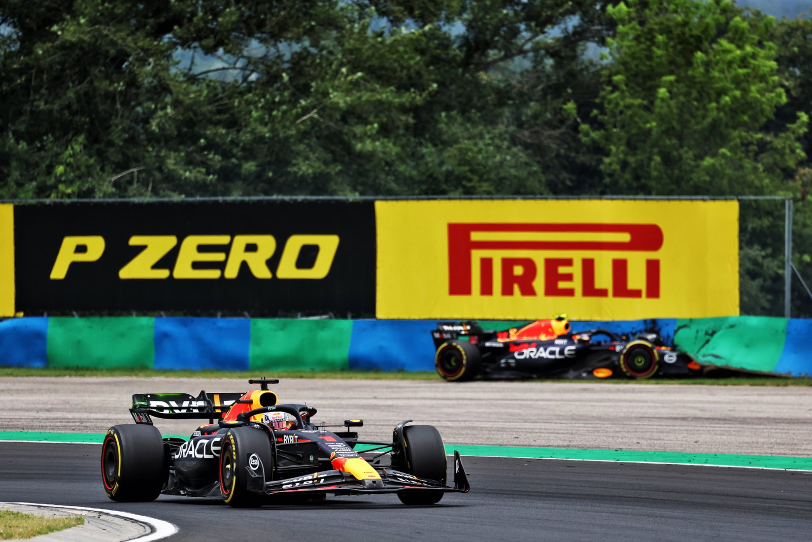 Max Verstappen (NLD) Red Bull Racing RB19 passes Sergio Perez (MEX) Red Bull Racing RB19, who crashed in the first practice