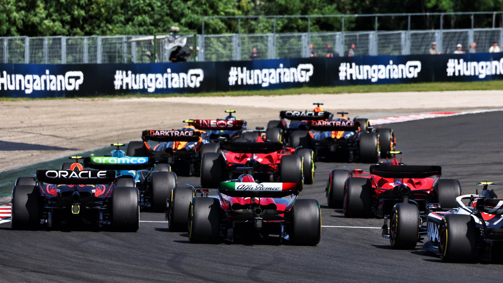 Sergio Perez (MEX) Red Bull Racing RB19 and Valtteri Bottas (FIN) Alfa Romeo F1 Team C43 at the start of the race. Formula