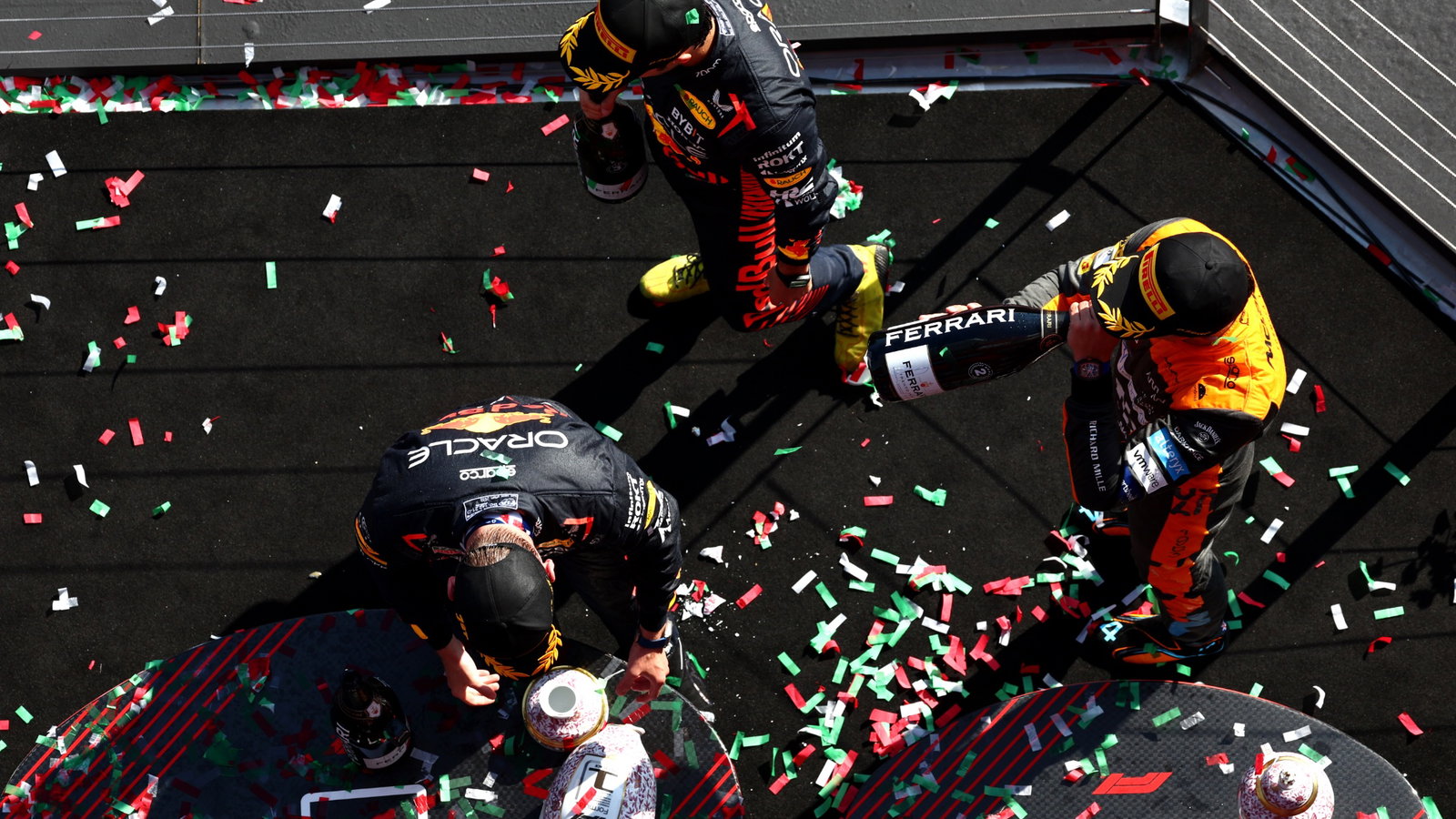 Max Verstappen (NLD) Red Bull Racing retrieves his broken trophy on the podium with Sergio Perez (MEX) Red Bull Racing and