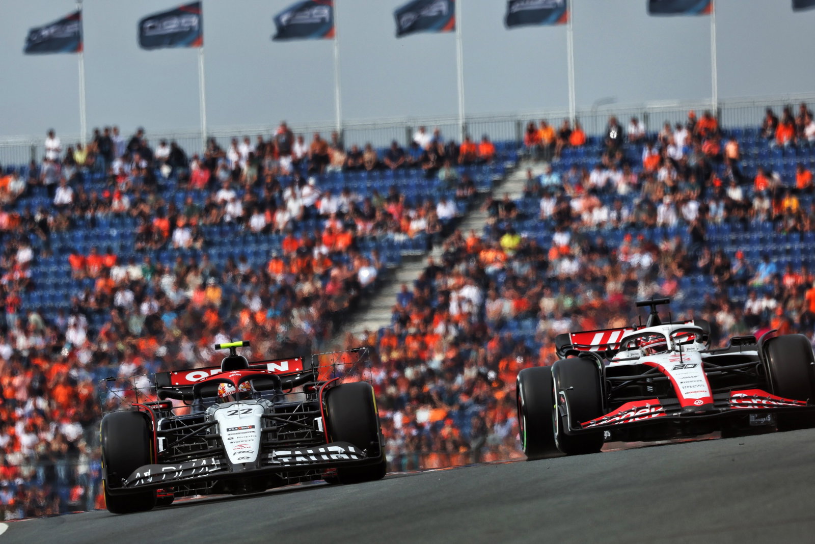Yuki Tsunoda (JPN) AlphaTauri AT04 and Kevin Magnussen (DEN) Haas VF-23. Formula 1 World Championship, Rd 14, Dutch Grand