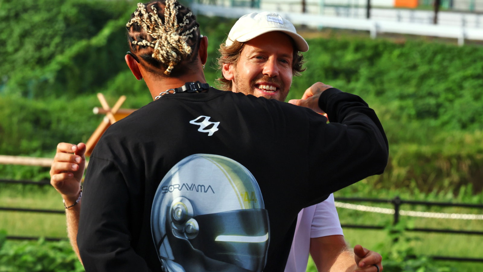 (L to R): Lewis Hamilton (GBR) Mercedes AMG F1 with Sebastian Vettel (GER) - Bee Hotel at Buzzin' Corner. Formula 1 World