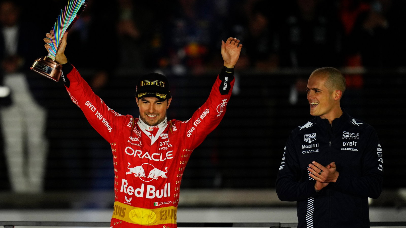 Sergio Perez (MEX) Red Bull Racing celebrates his third position on the podium. Formula 1 World Championship, Rd 22, Las