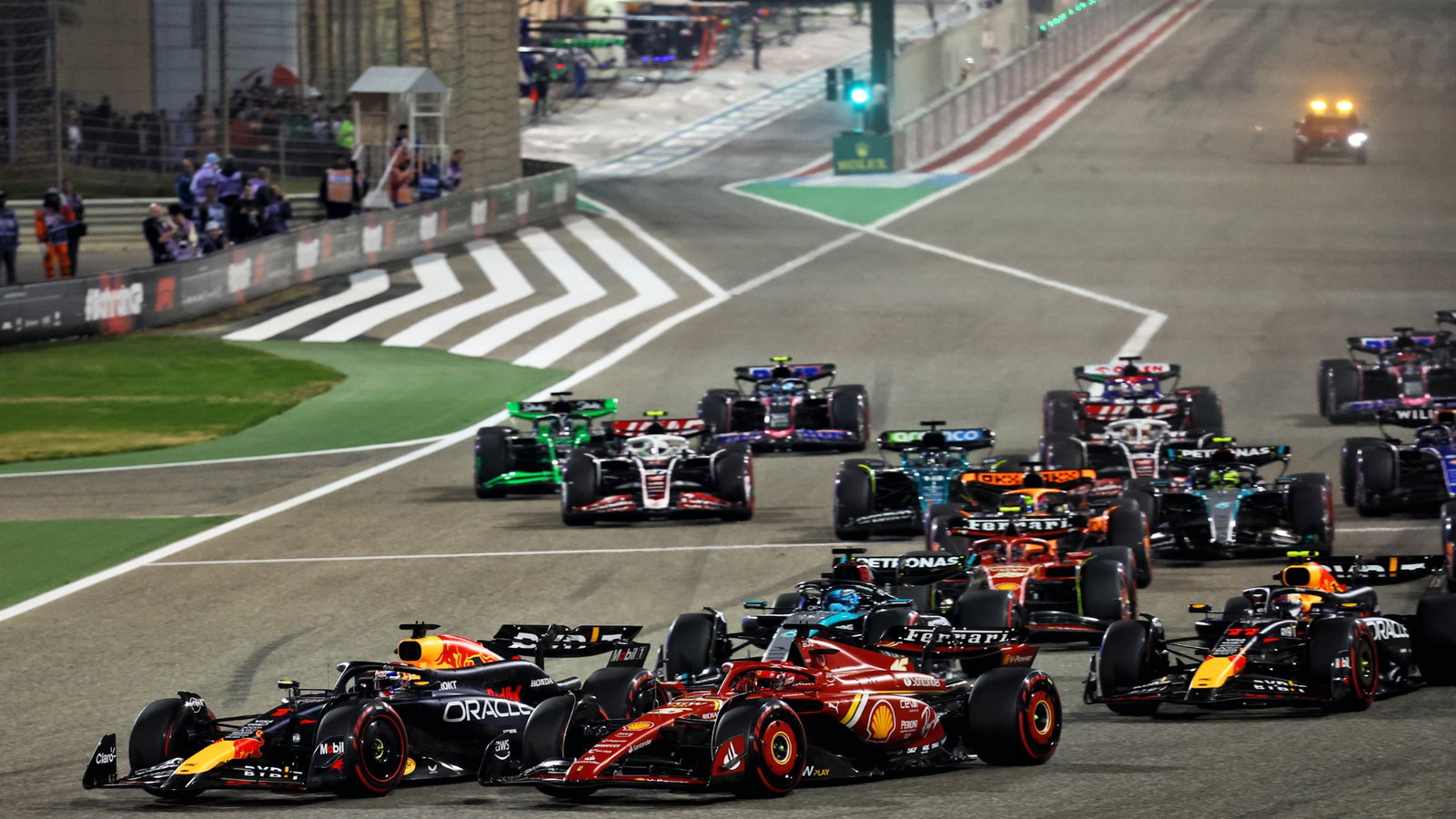 Max Verstappen (NLD) Red Bull Racing RB20 leads Charles Leclerc (MON) Ferrari SF-24 at the start of the race. Formula 1