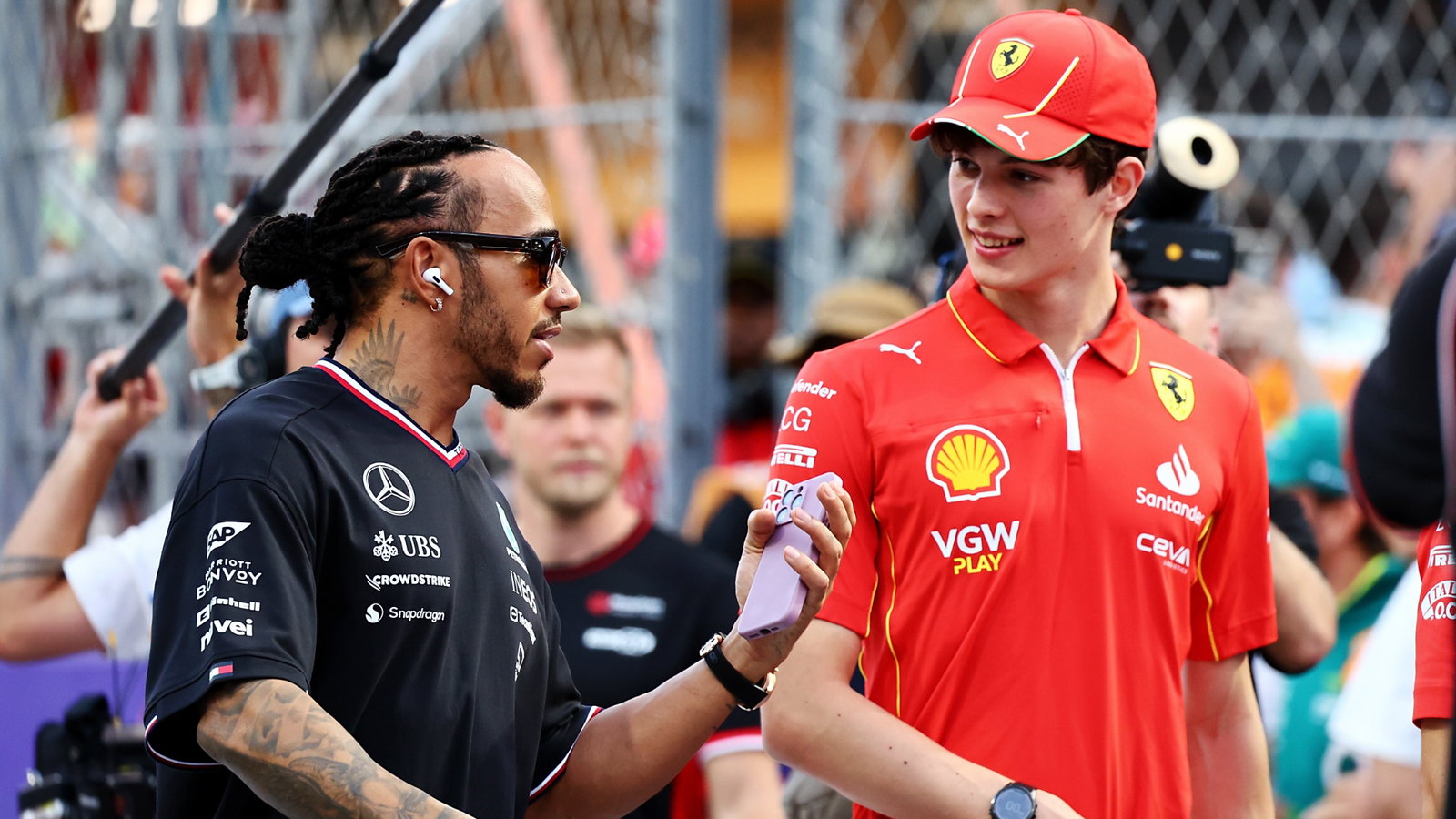 (L to R): Lewis Hamilton (GBR) Mercedes AMG F1 and Oliver Bearman (GBR) Ferrari Reserve Driver on the drivers' parade.
