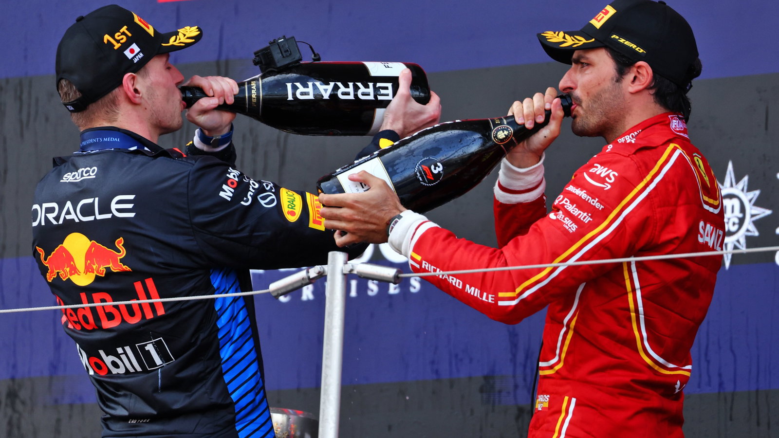 (L to R): Race winner Max Verstappen (NLD) Red Bull Racing celebrates on the podium with third placed Carlos Sainz Jr (ESP)
