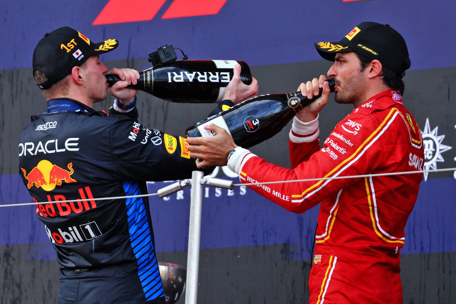 (L to R): Race winner Max Verstappen (NLD) Red Bull Racing celebrates on the podium with third placed Carlos Sainz Jr (ESP)