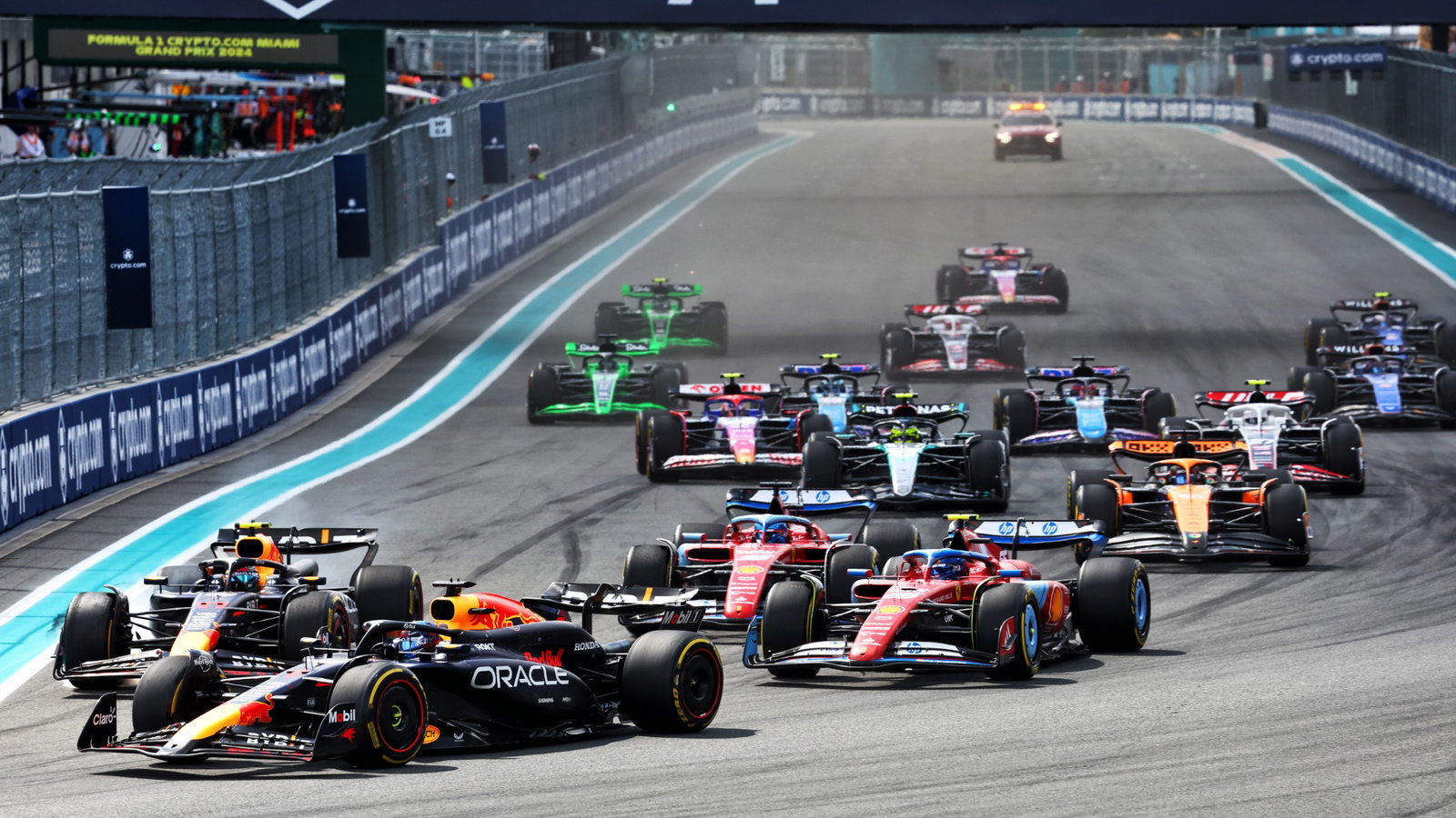 Max Verstappen (NLD) Red Bull Racing RB20 leads a late braking team mate Sergio Perez (MEX) Red Bull Racing RB20 at the