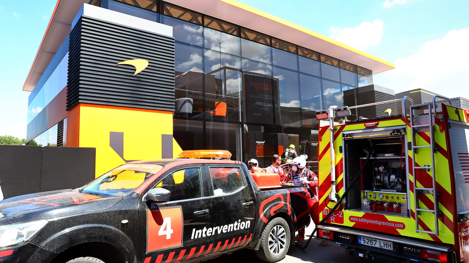 A fire in the McLaren motorhome is tended to by fire fighters. Formula 1 World Championship, Rd 10, Spanish Grand Prix,