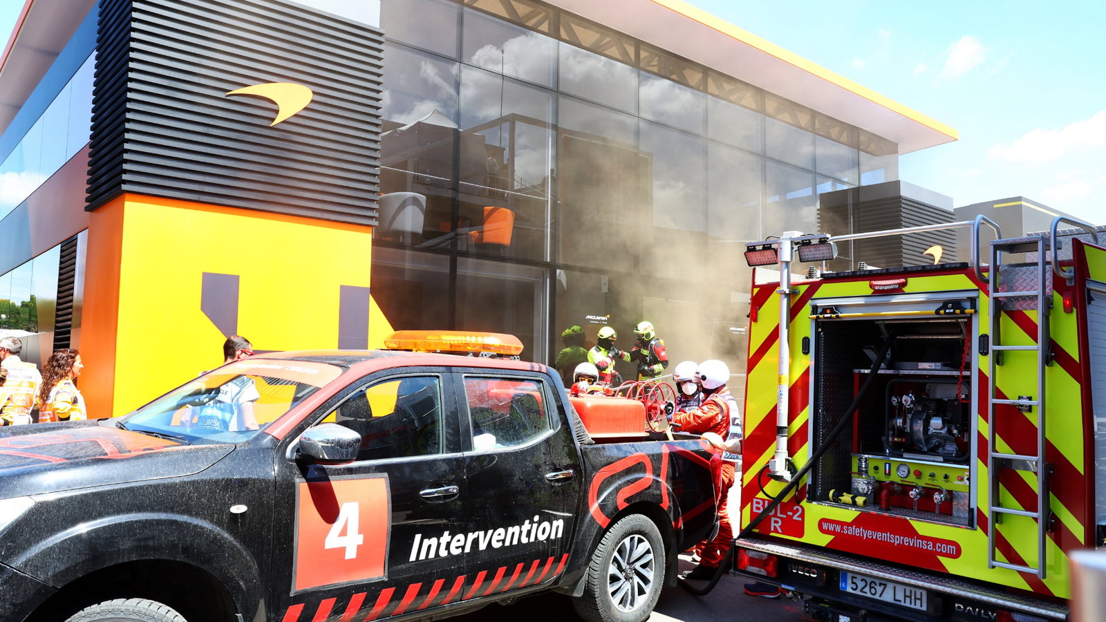 A fire in the McLaren motorhome is tended to by fire fighters. Formula 1 World Championship, Rd 10, Spanish Grand Prix,