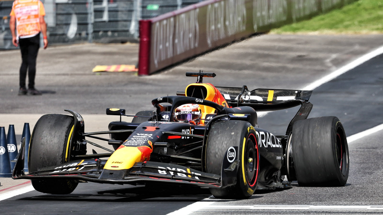 Max Verstappen (NLD) Red Bull Racing RB20 makes a pit stop with a puncture after collision with Lando Norris (GBR) McLaren