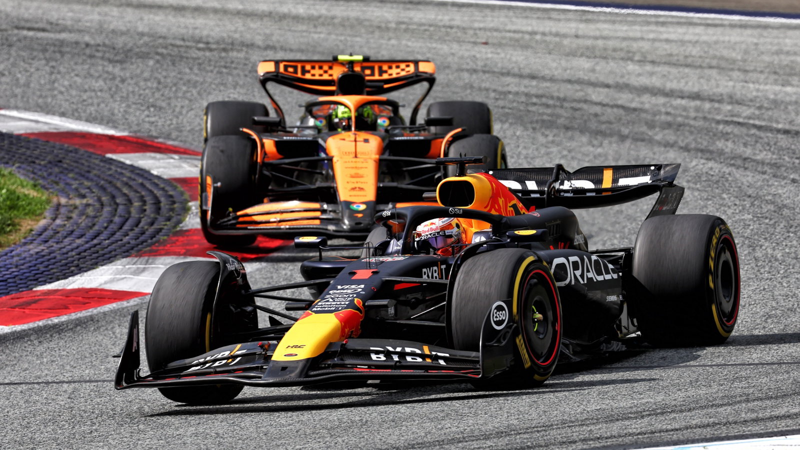 Max Verstappen (NLD) Red Bull Racing RB20 leads Lando Norris (GBR) McLaren MCL38. Formula 1 World Championship, Rd 11,