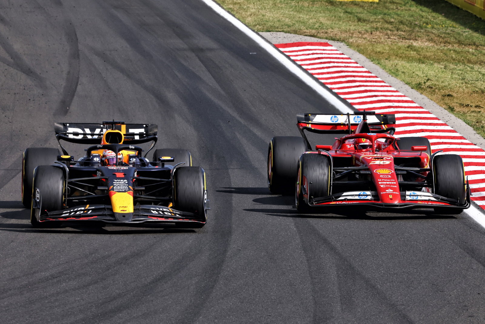 Max Verstappen (NLD) Red Bull Racing RB20 and Charles Leclerc (MON) Ferrari SF-24 battle for position. Formula 1 World